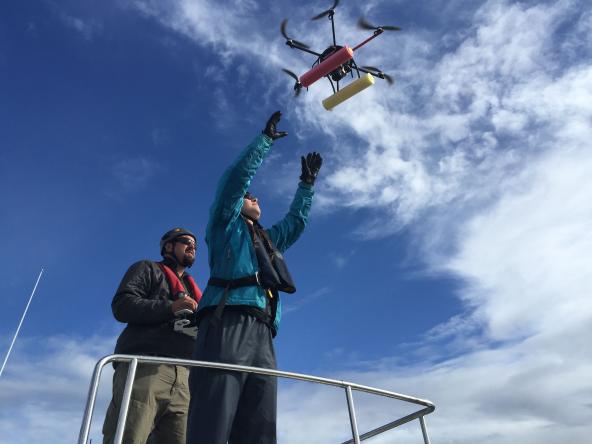 John Durban, left, pilots a small hexacopter into the hands of Holly Fearnbach. The two biologists, both with NOAA’s Southwest Fisheries Science Center, use the remote-controlled aircraft to capture detailed images of killer whales. Photo: NOAA Fisheries